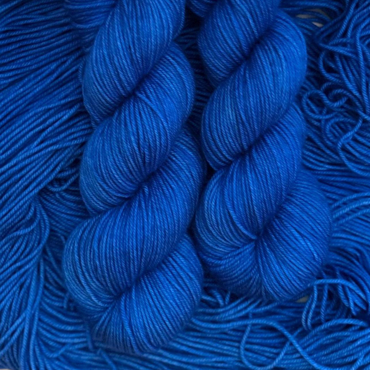 Close-up of blue hand dyed yarn skeins with a blurred background