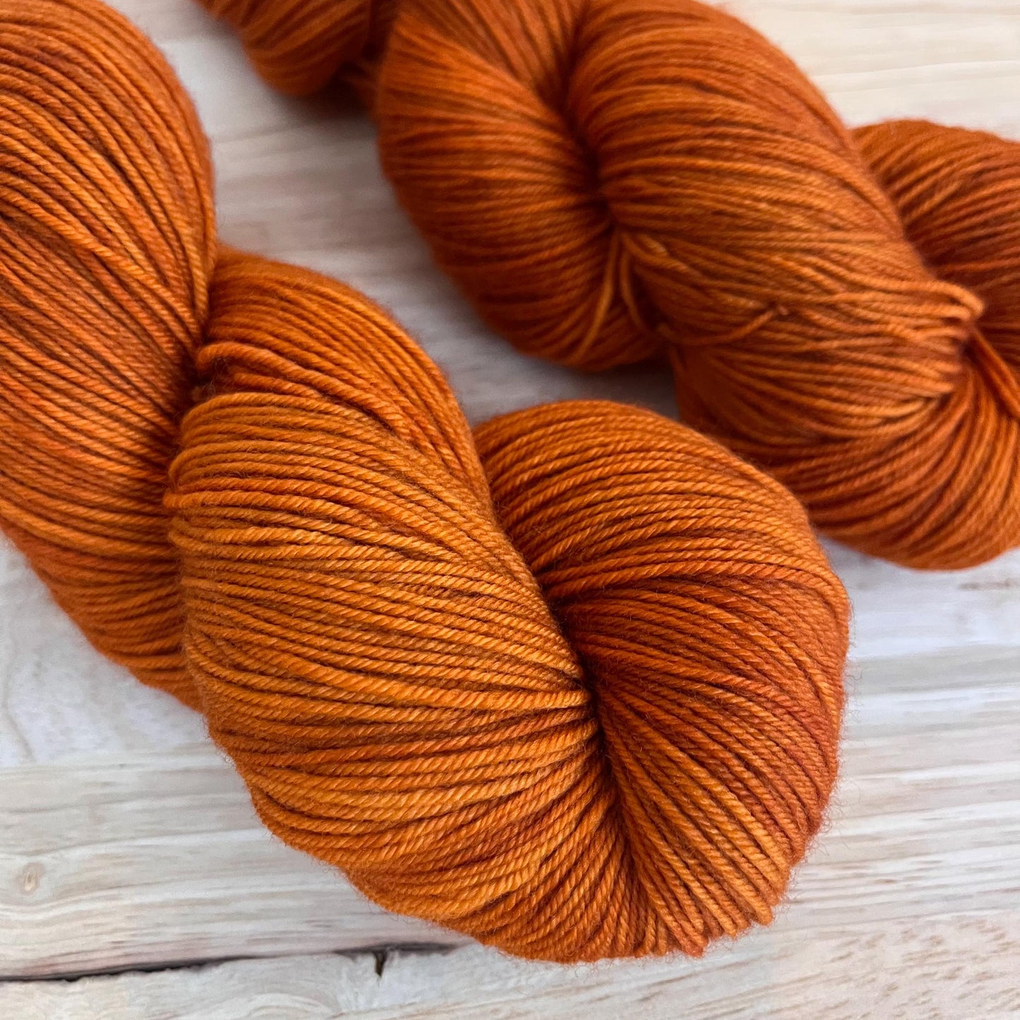 2 skeins of sock weight rust orange yarn.