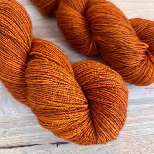 2 skeins of sock weight rust orange yarn.