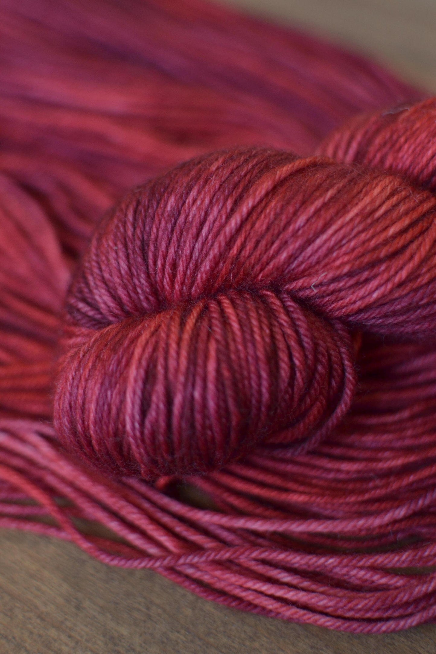 Twisted hank of dark red wool yarn
