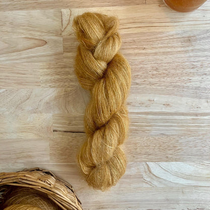 A skein of camel colored mohair and silk yarn.