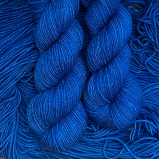 Close-up of blue hand dyed yarn skeins with a blurred background