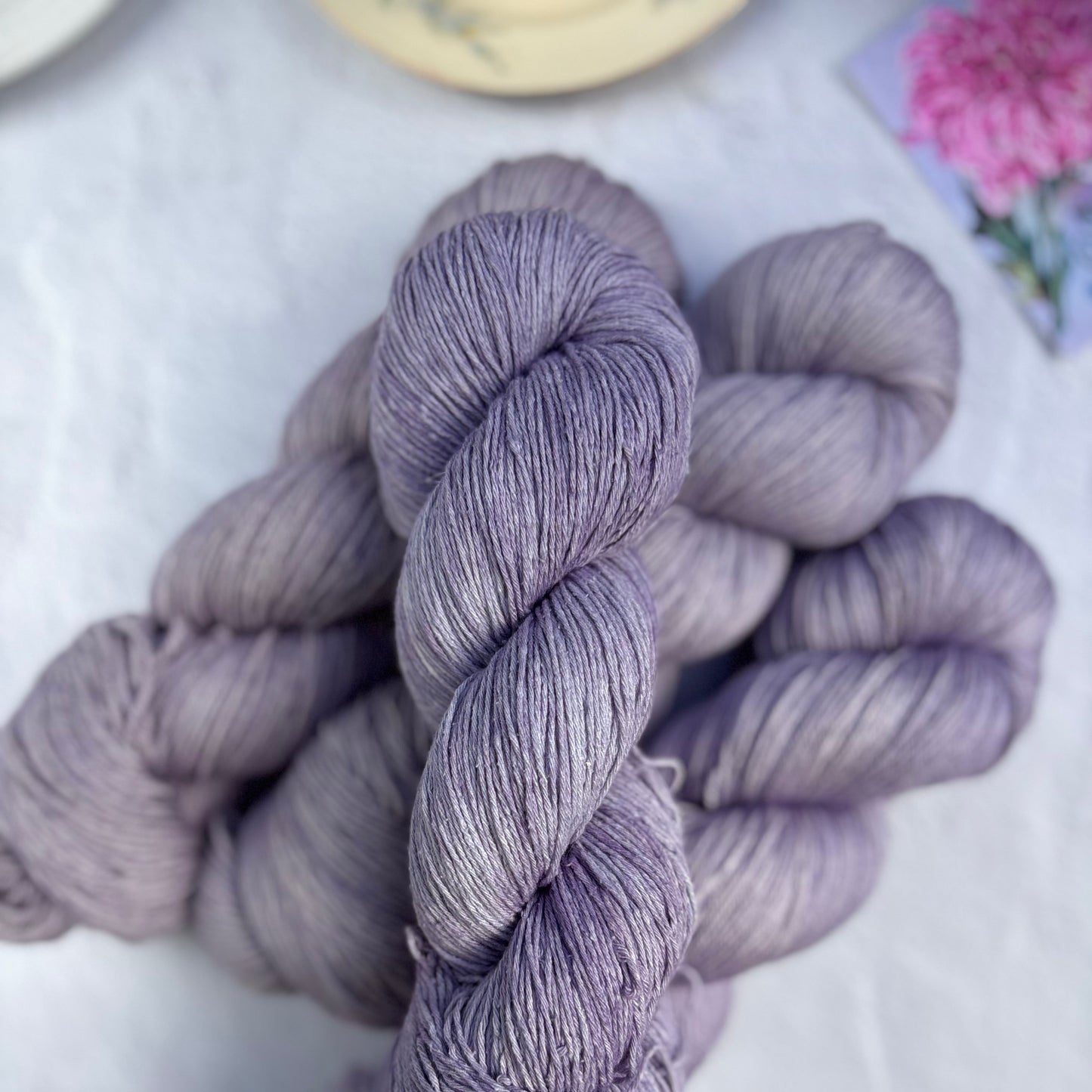 Purple skein of yarn on a white surface