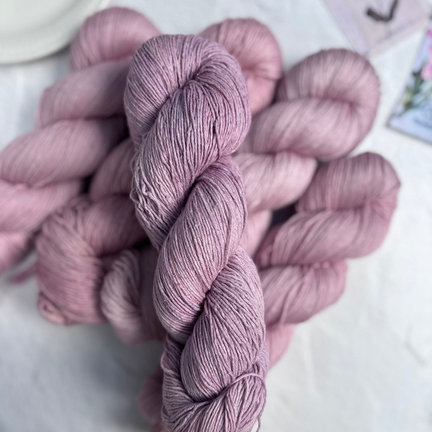 Skeins of pink yarn on a light surface
