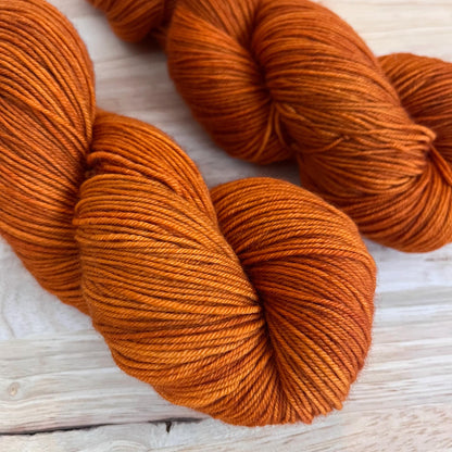 2 skeins of sock weight rust orange yarn.