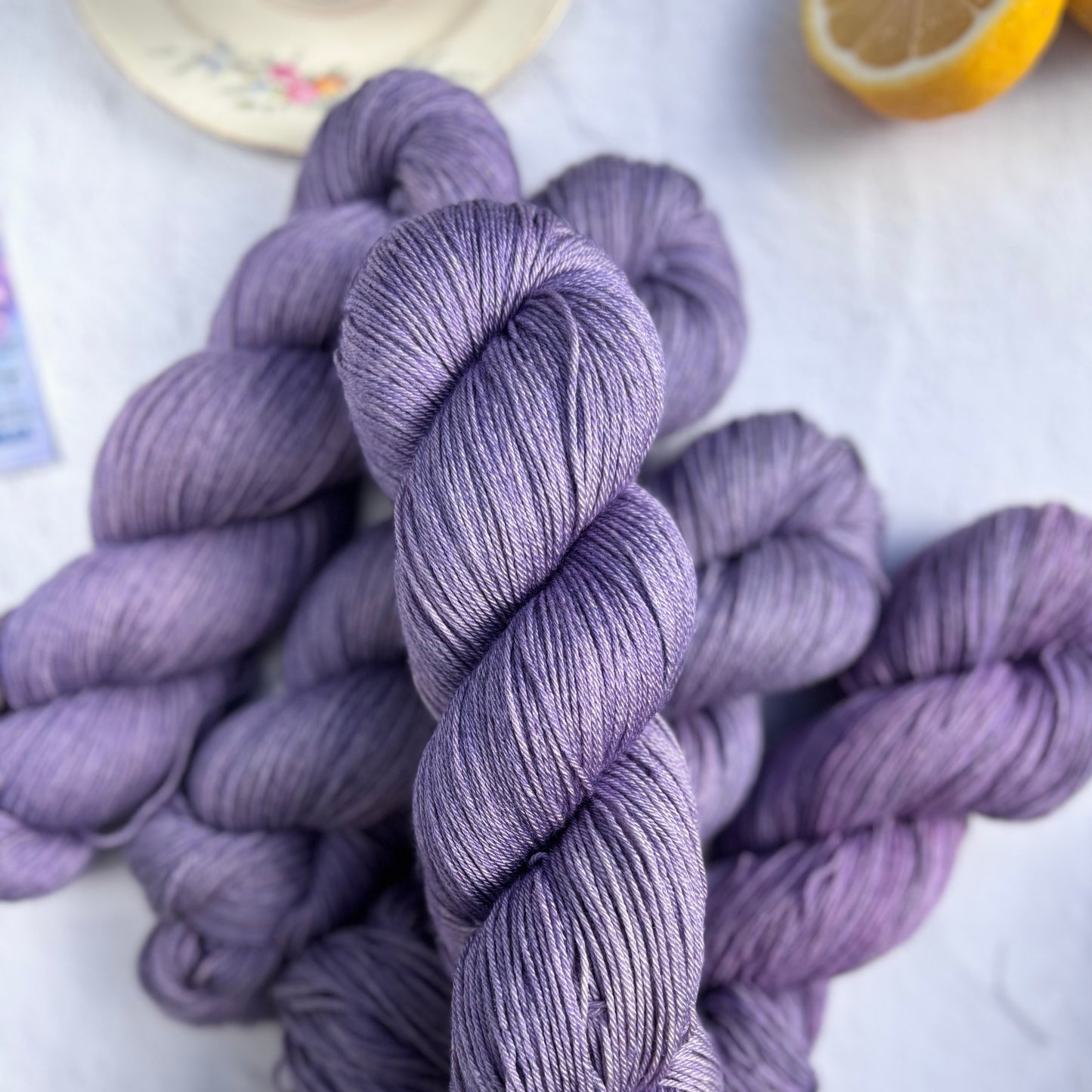 Purple yarn skeins on a light background