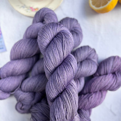 Purple yarn skeins on a light background