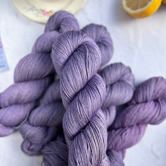 Purple yarn skeins on a light background
