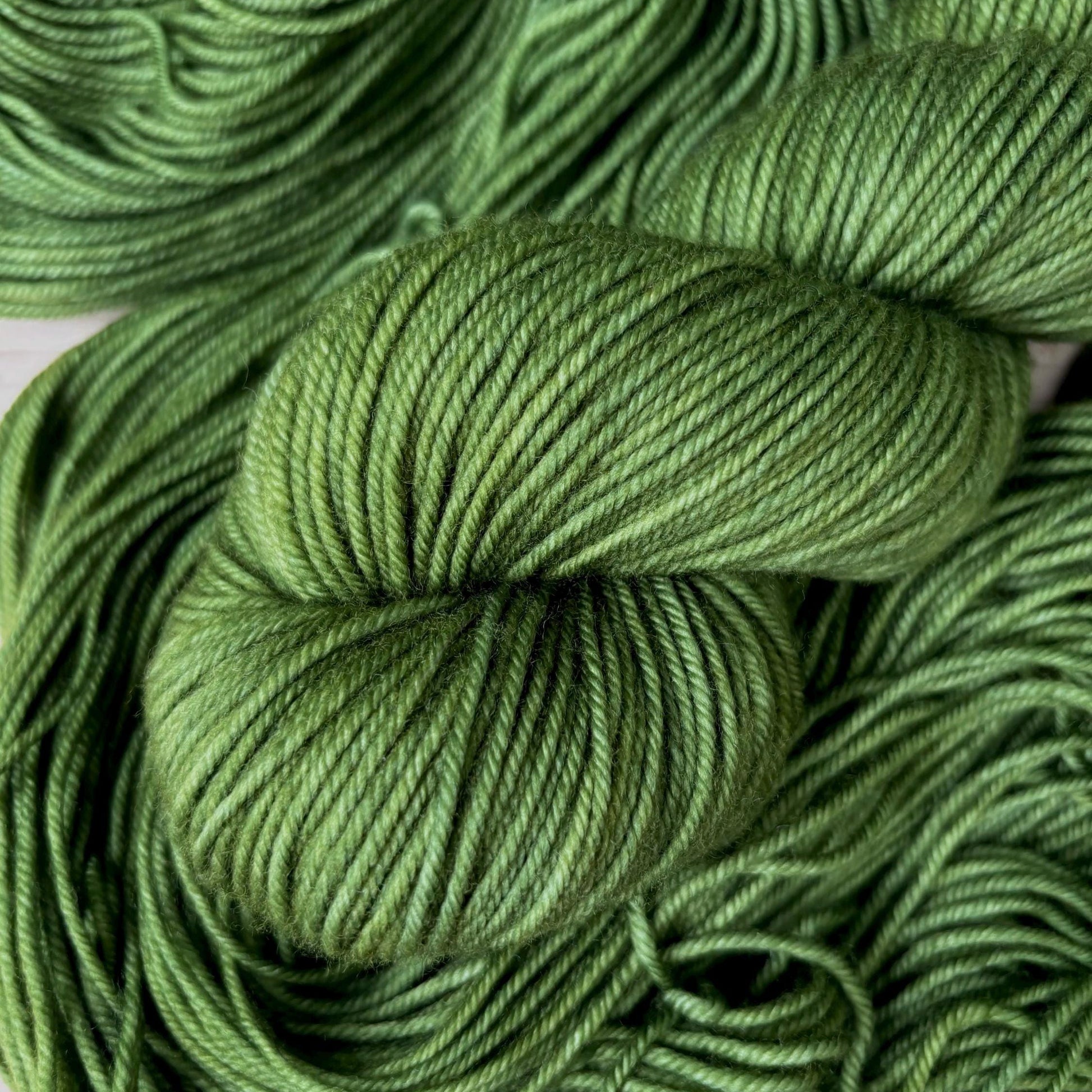 A skein of hand dyed green yarn